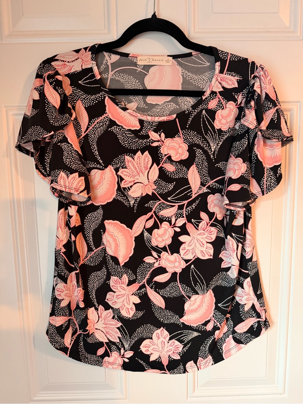 Have Black Top with Pink Floral Motif and Ruffled Sleeves